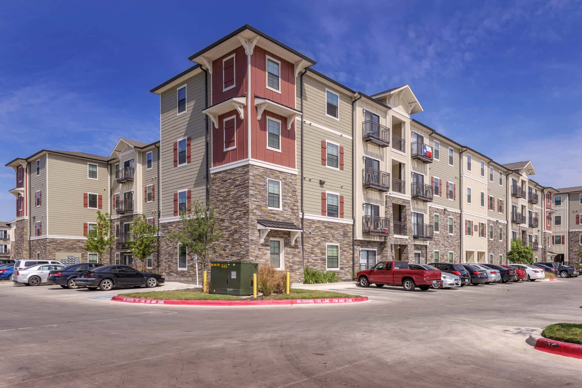 arba san marcos off campus apartments near texas state university community building exterior and parking spaces