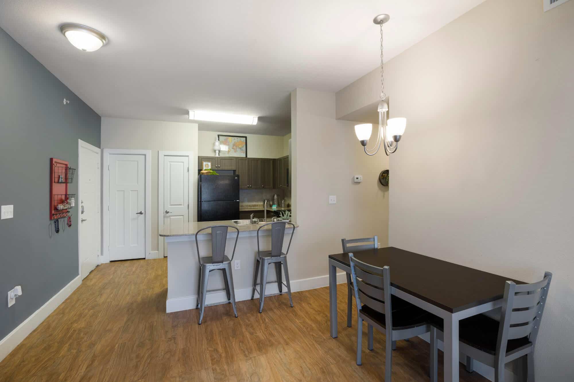 arba san marcos off campus apartments near texas state university open floor plan dining table kitchen with eat in bar and bar stool seating
